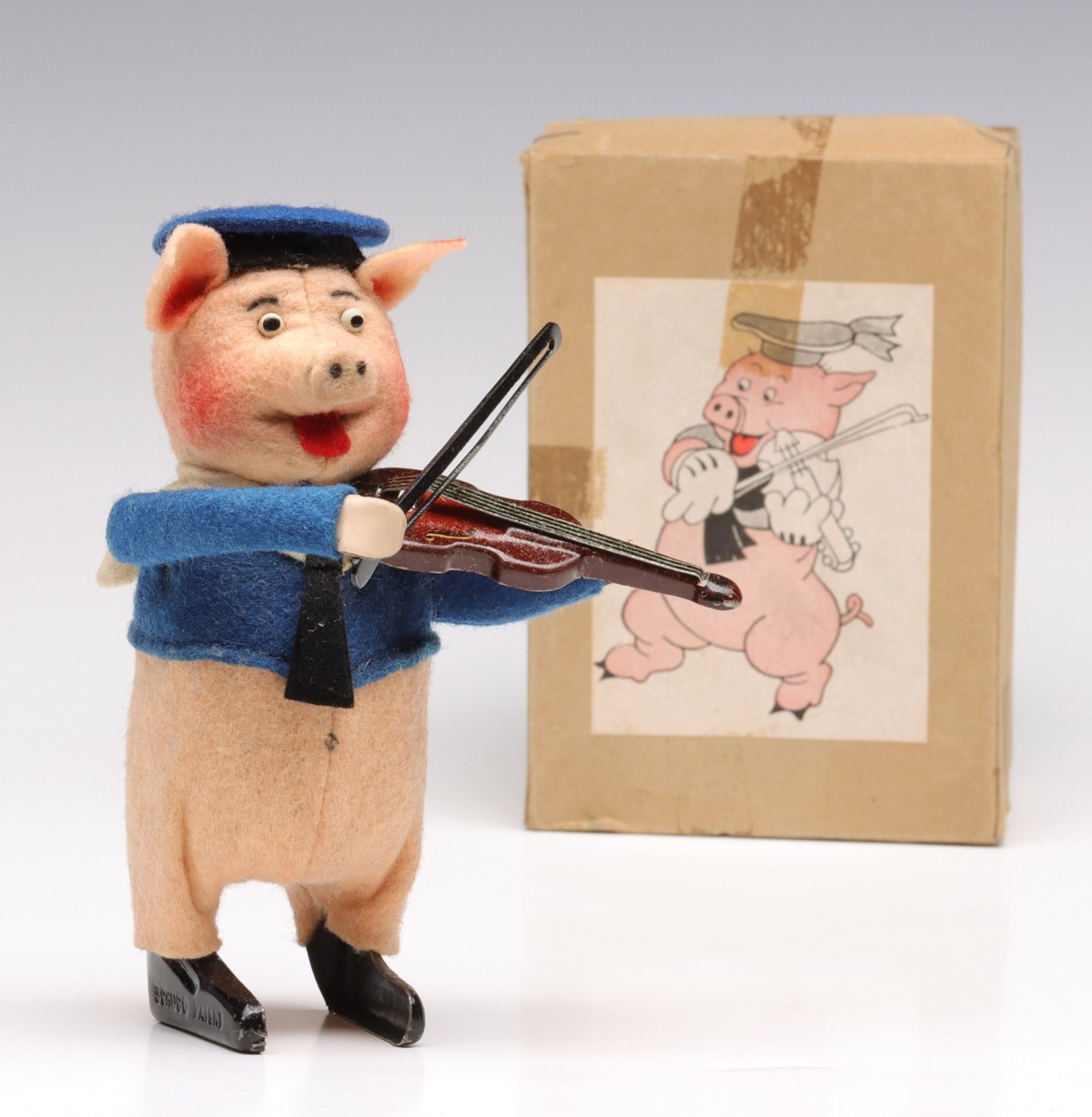 A SCHUCO WIND-UP PIG WITH FIDDLE IN ORIGINAL BOX