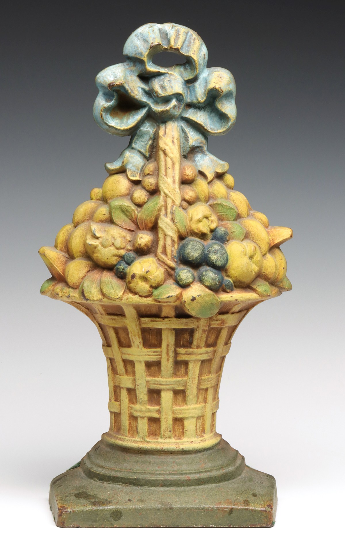 AN UNUSUALLY LARGE CAST IRON FLOWER BASKET DOOR STOP