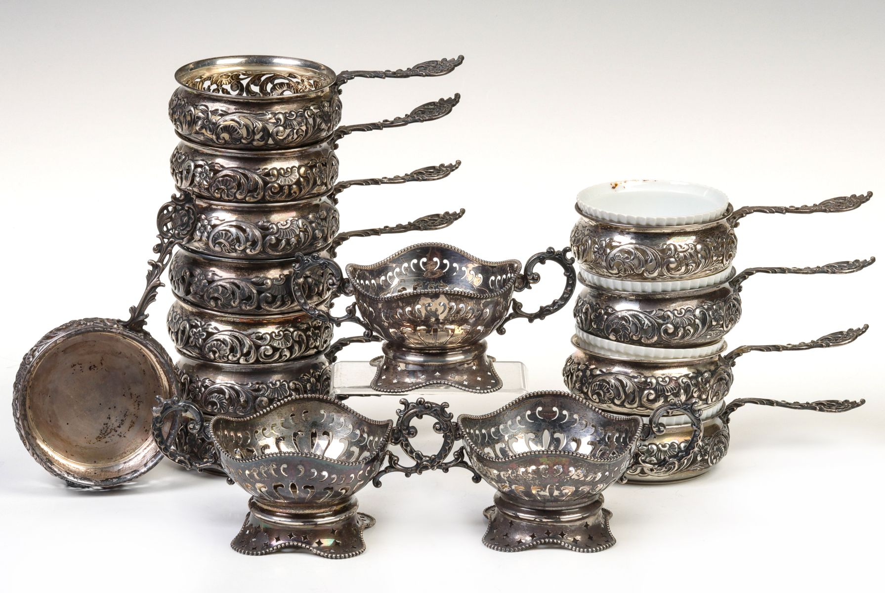 A SET OF TWELVE ORNATE STERLING SILVER RAMEKINS