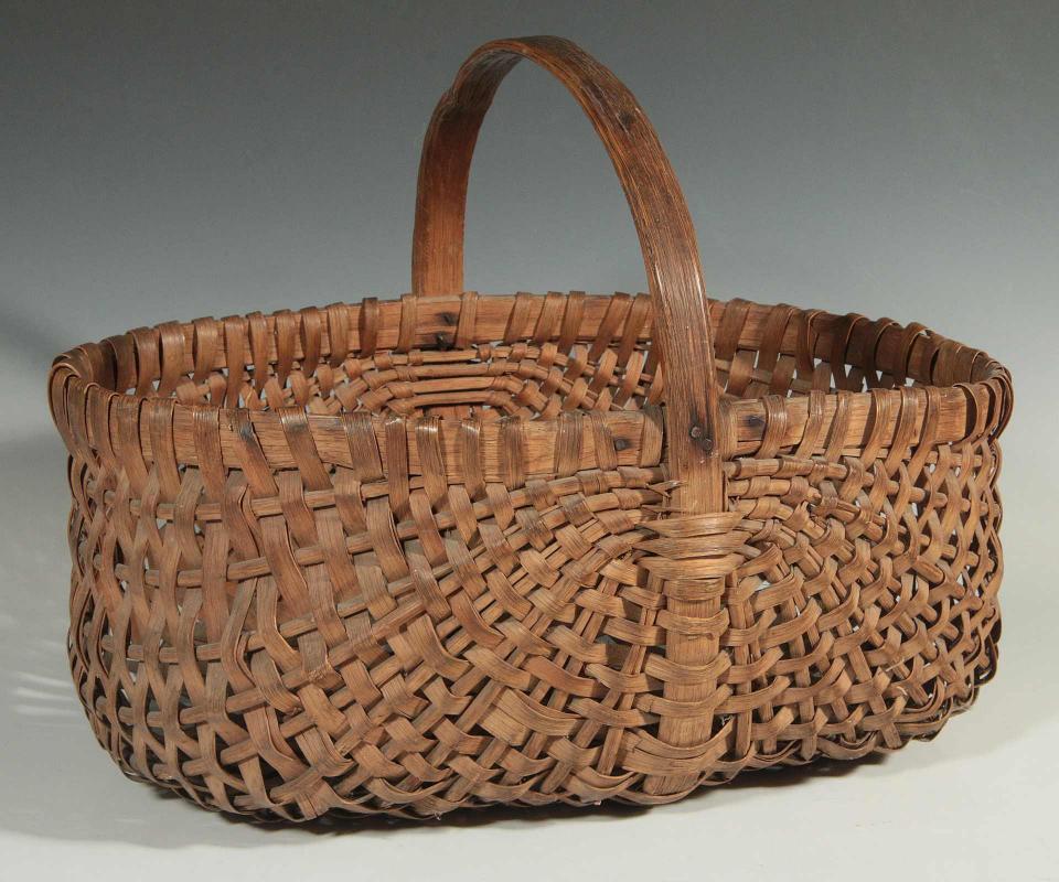 AN OAK SPLINT BASKET BY THE WESTFALLS, BUFFALO MO