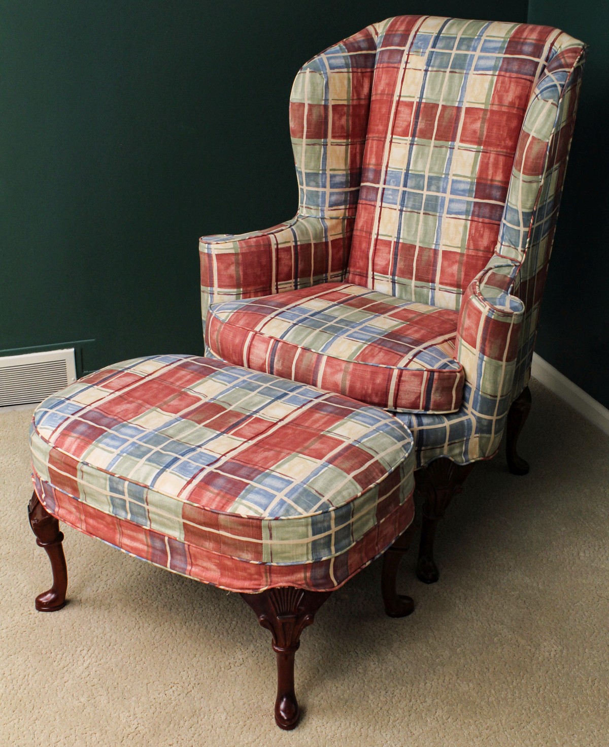 A CUSTOM UPHOLSTERED WINGBACK CHAIR AND OTTOMAN