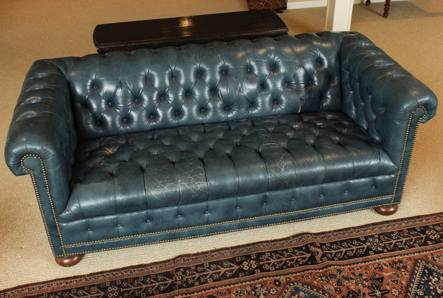 A VINTAGE BUTTON-TUCKED CHESTERFIELD SOFA