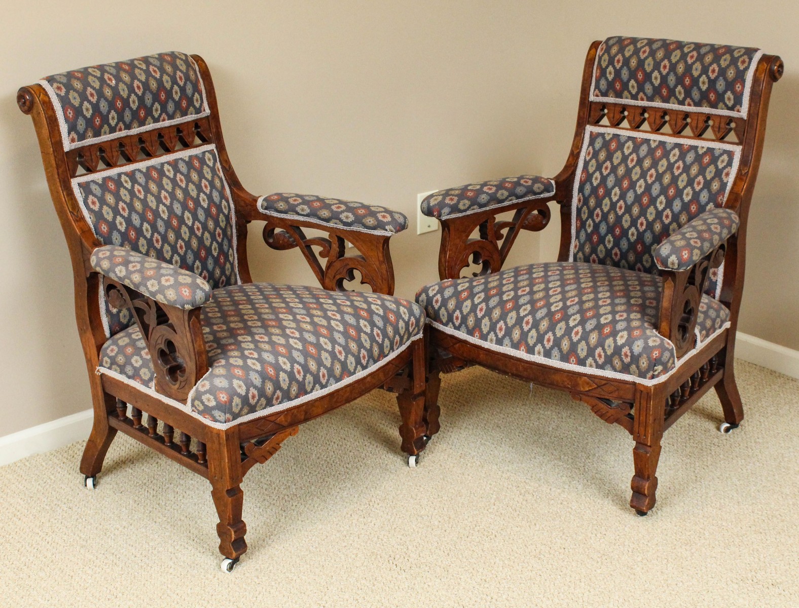 AN INTERESTING PAIR OF VICTORIAN WALNUT ARM CHAIRS
