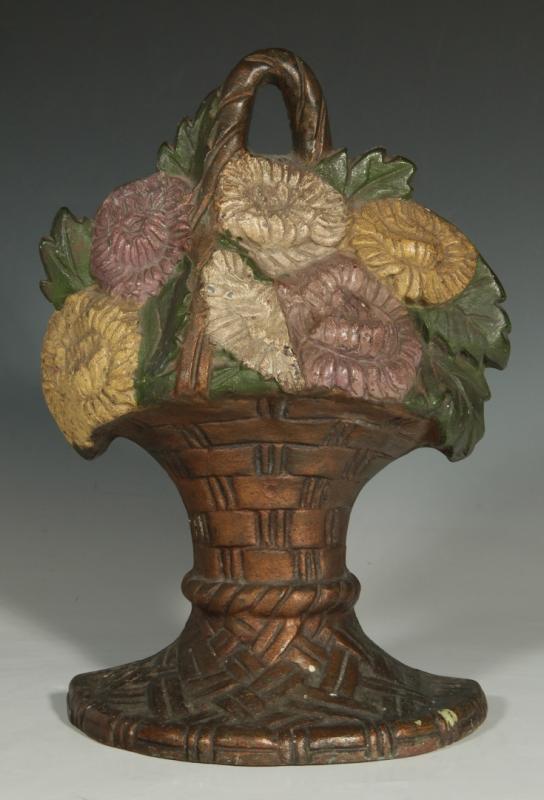 A WAVERLY FLOWER BASKET CAST IRON DOOR STOP, 1925