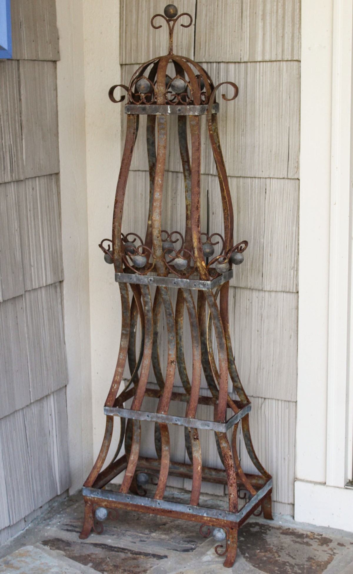 AN INTERESTING UPRIGHT CAST AND STRAPIRON PLANT STAND