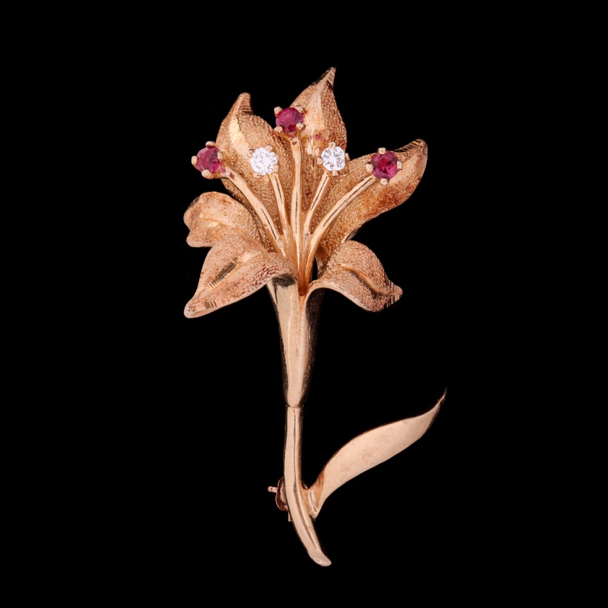 A 14 KARAT GOLD FLORIFORM PIN WITH DIAMONDS AND RUBIES