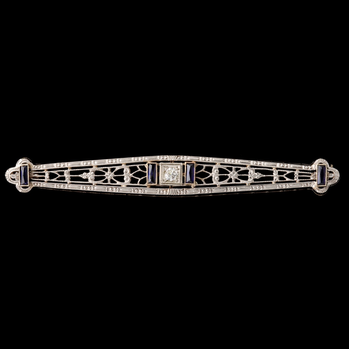 A 14K WHITE GOLD BAR PIN WITH DIAMOND AND SAPPHIRES