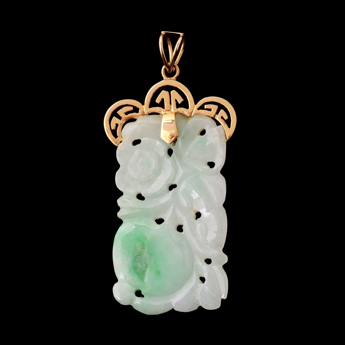 A CARVED JADE PLAQUE WITH 14 KARAT GOLD MOUNT