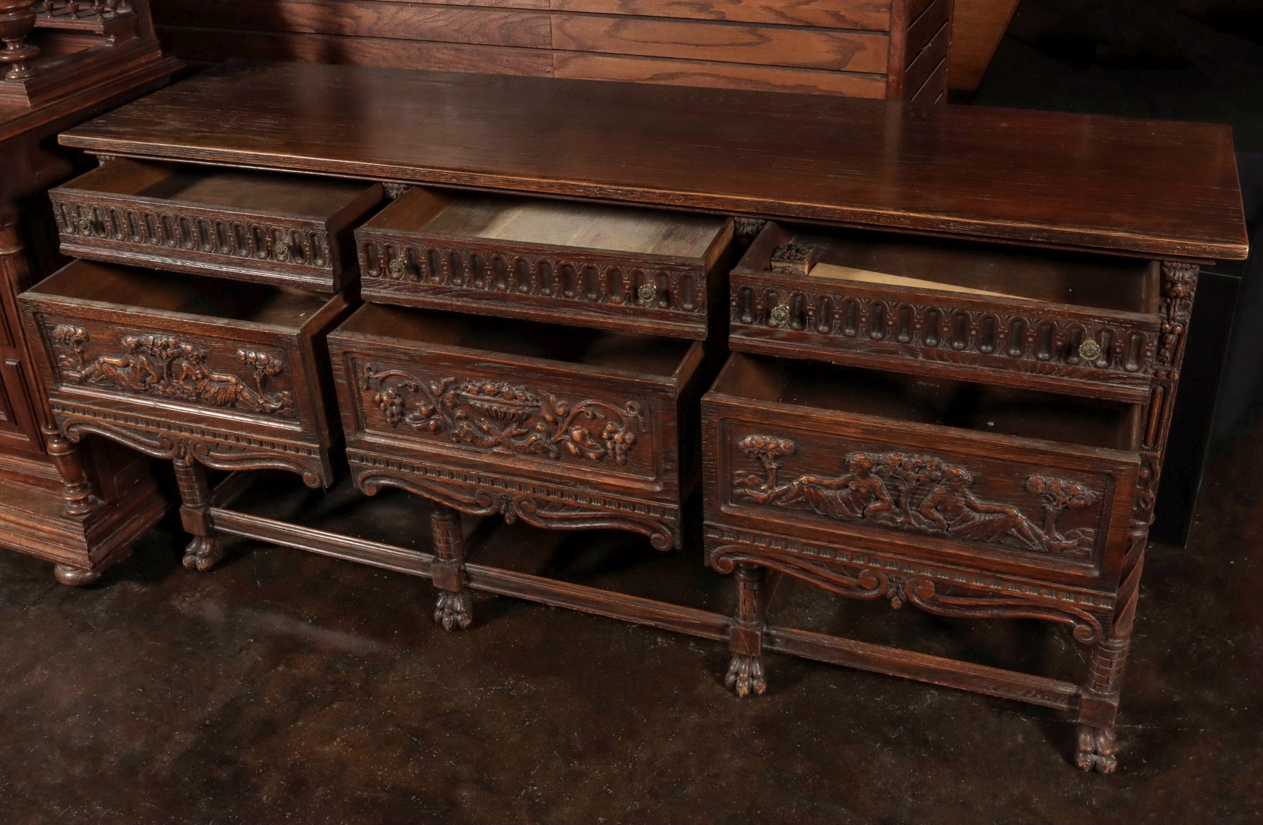 A HEAVILY CARVED OAK PAW FOOT SIDEBOARD CIRCA 1900