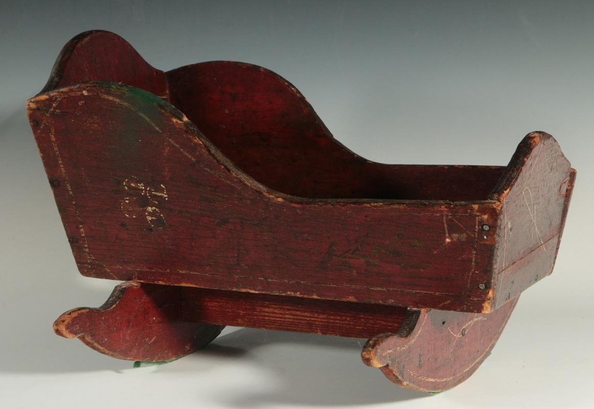 A PAINTED PRIMITIVE ROCKING DOLL CRADLE