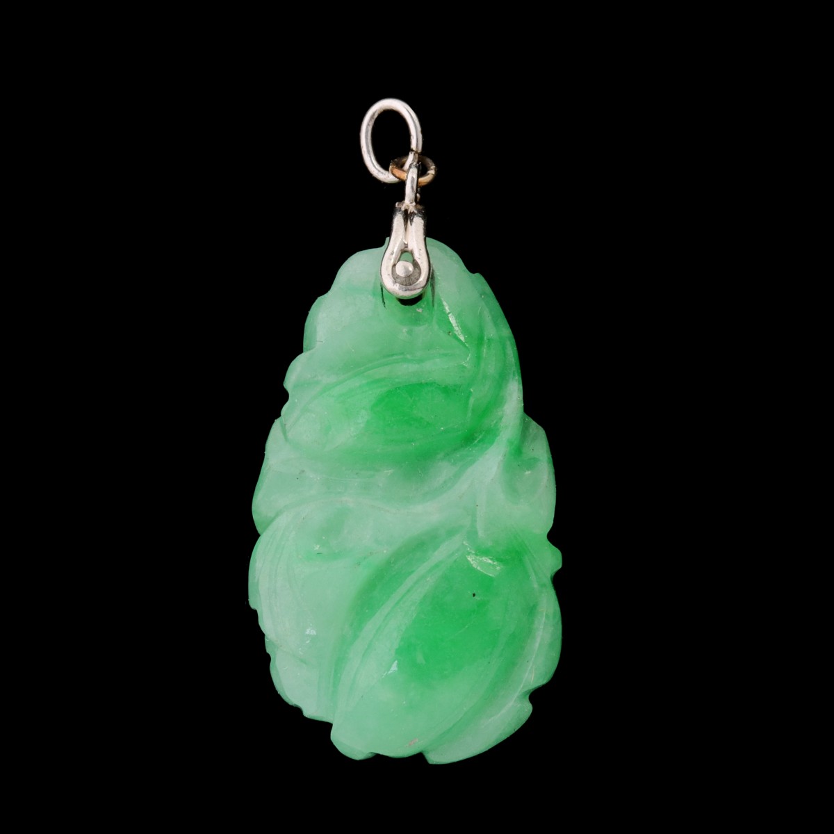 A CARVED JADE PENDANT WITH SILVER BAIL