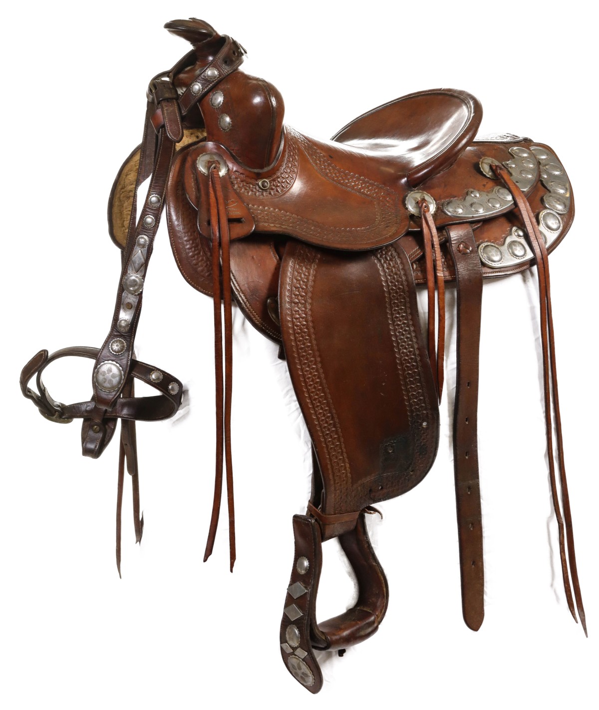 A RHODES KANSAS CITY SADDLE WITH FANCY METAL CONCHOS