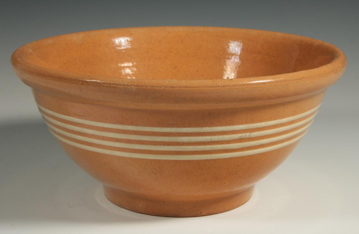 AN ANTIQUE YELLOW WARE BANDED BOWL