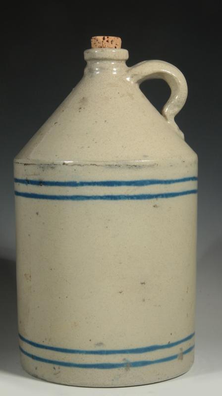 AN ANTIQUE STONEWARE JUG WITH BLUE SLIP BANDS