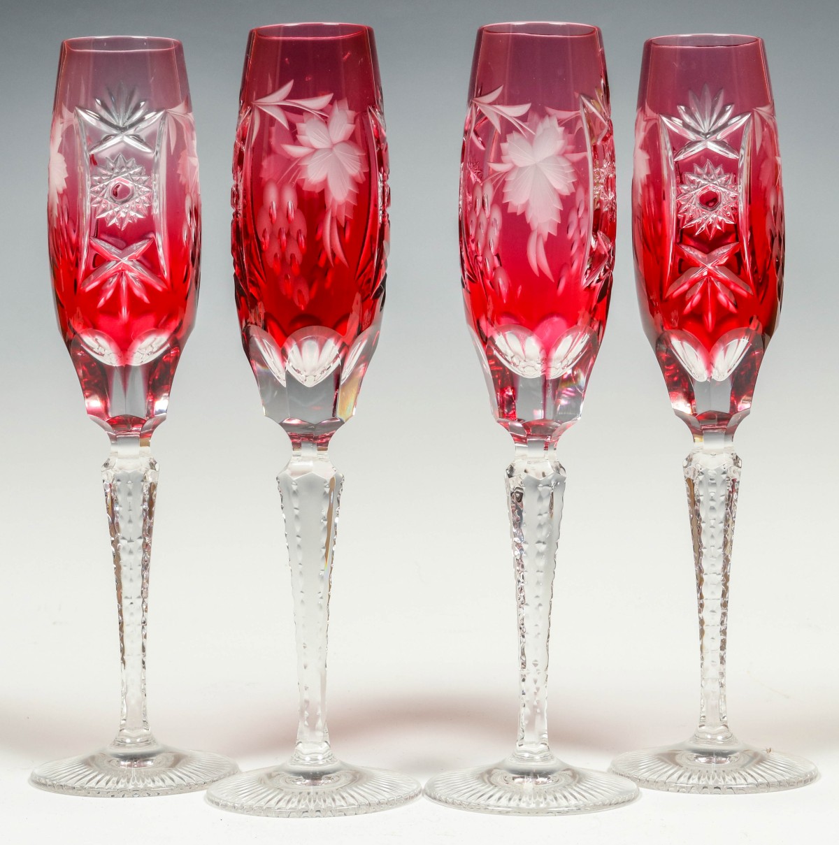 FOUR FINE CRANBERRY CUT TO CLEAR FLUTES