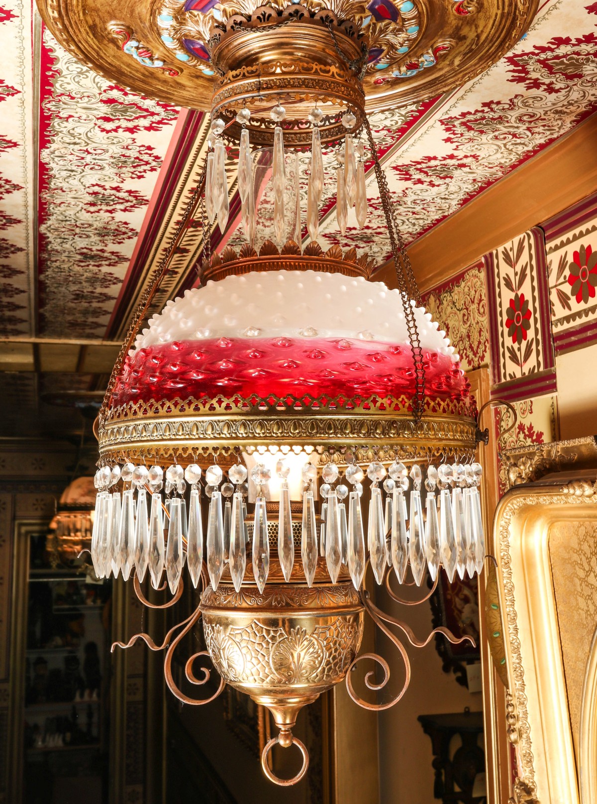 A HANGING LIBRARY LAMP WITH RUBINA HOBNAIL SHADE