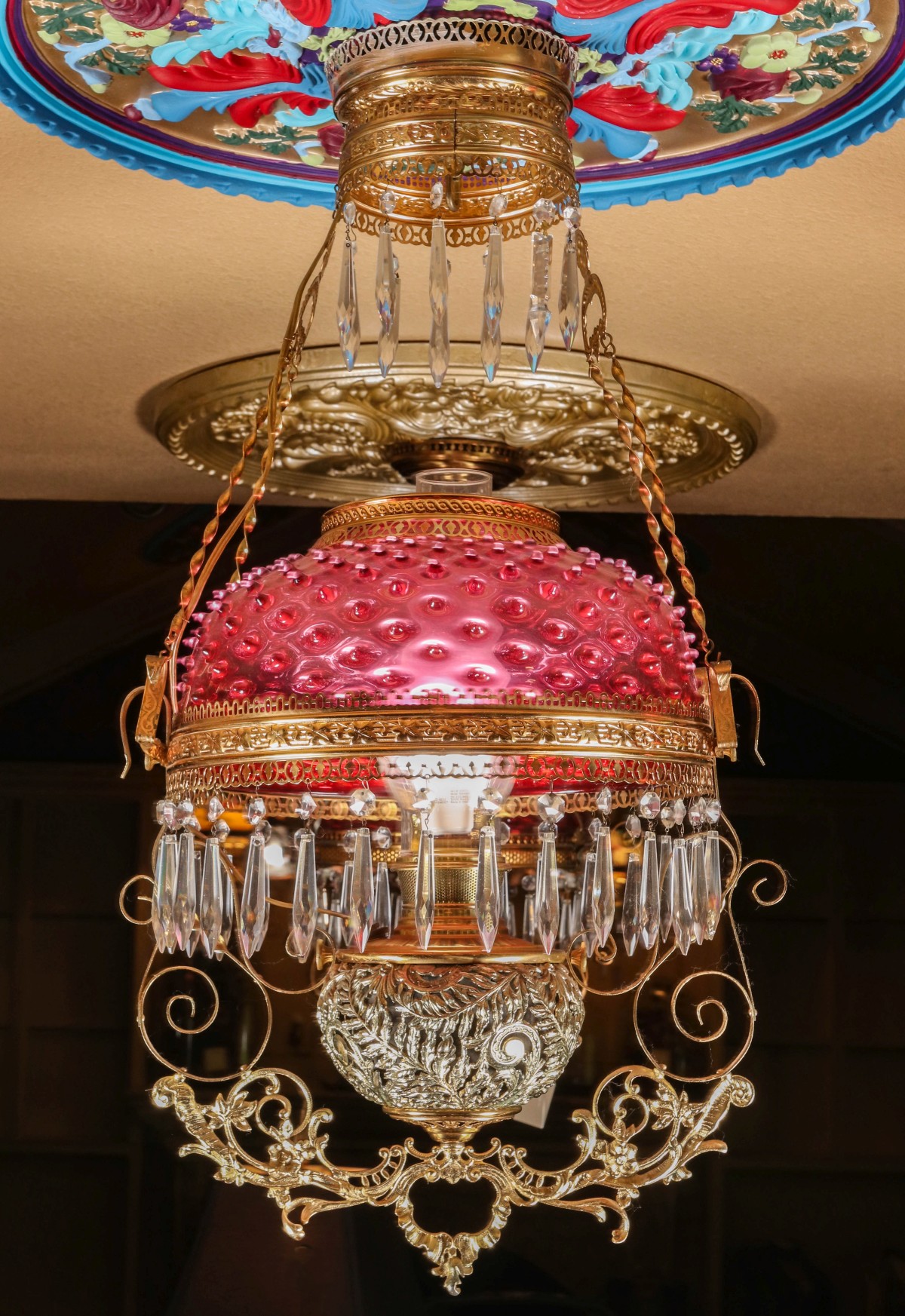 A HANGING LIBRARY LAMP WITH ORNATE BRASS FERNERY