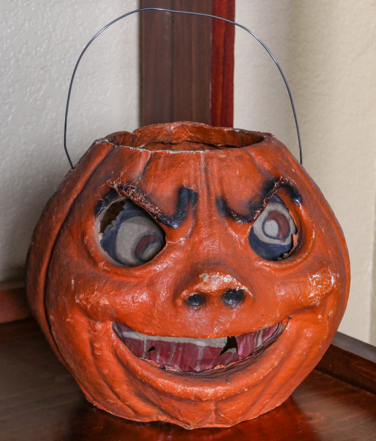 A SCOWLING PAPIER MACHE' HALLOWEEN JACK-O-LANTERN