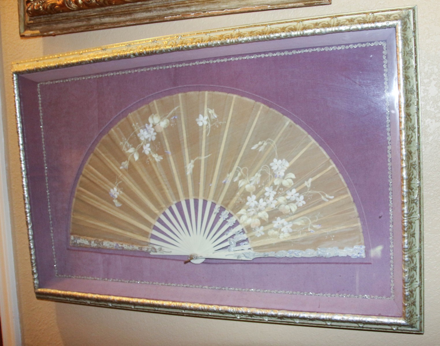 AN ANTIQUE HAND PAINTED FAN WITH CARVED STICKS