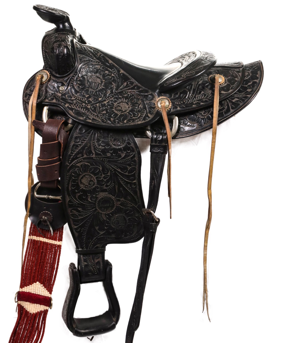 A DEEPLY CARVED MILLER KC FLORAL TOOLED ROPING SADDLE