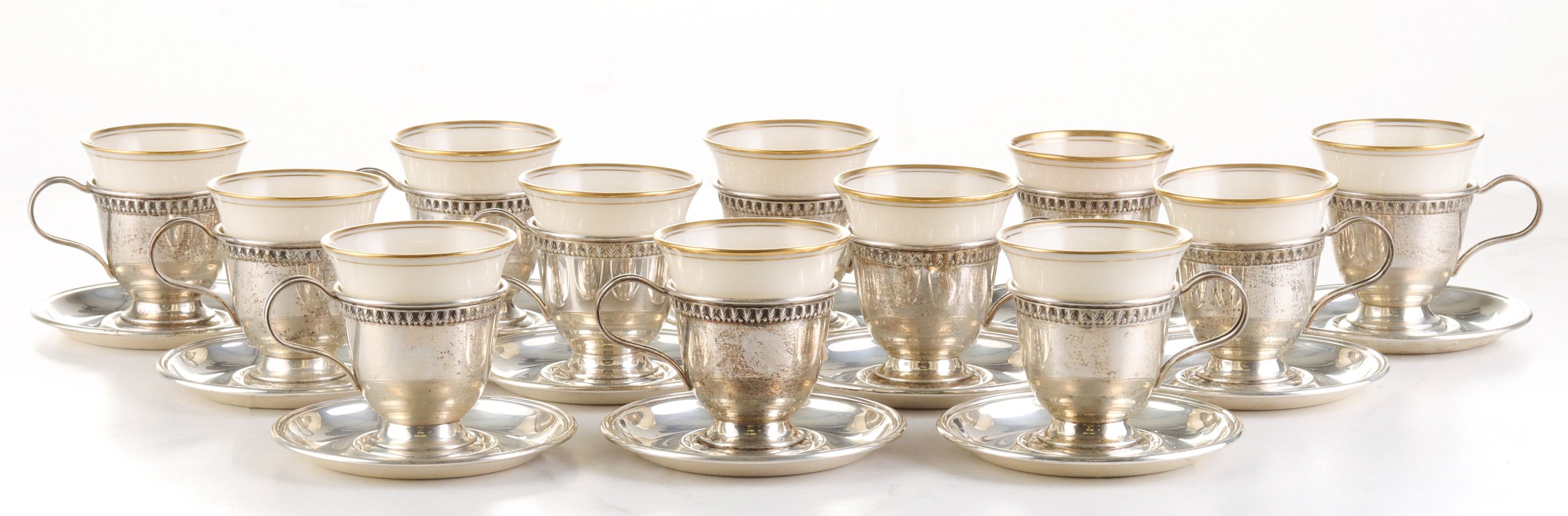 TWELVE LENOX PORCELAIN DEMITASSE IN STERLING LINERS