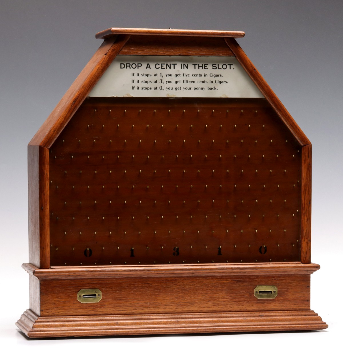 A RARE EARLY 1900s OAK CASE PENNY DROP TRADE STIMULATOR