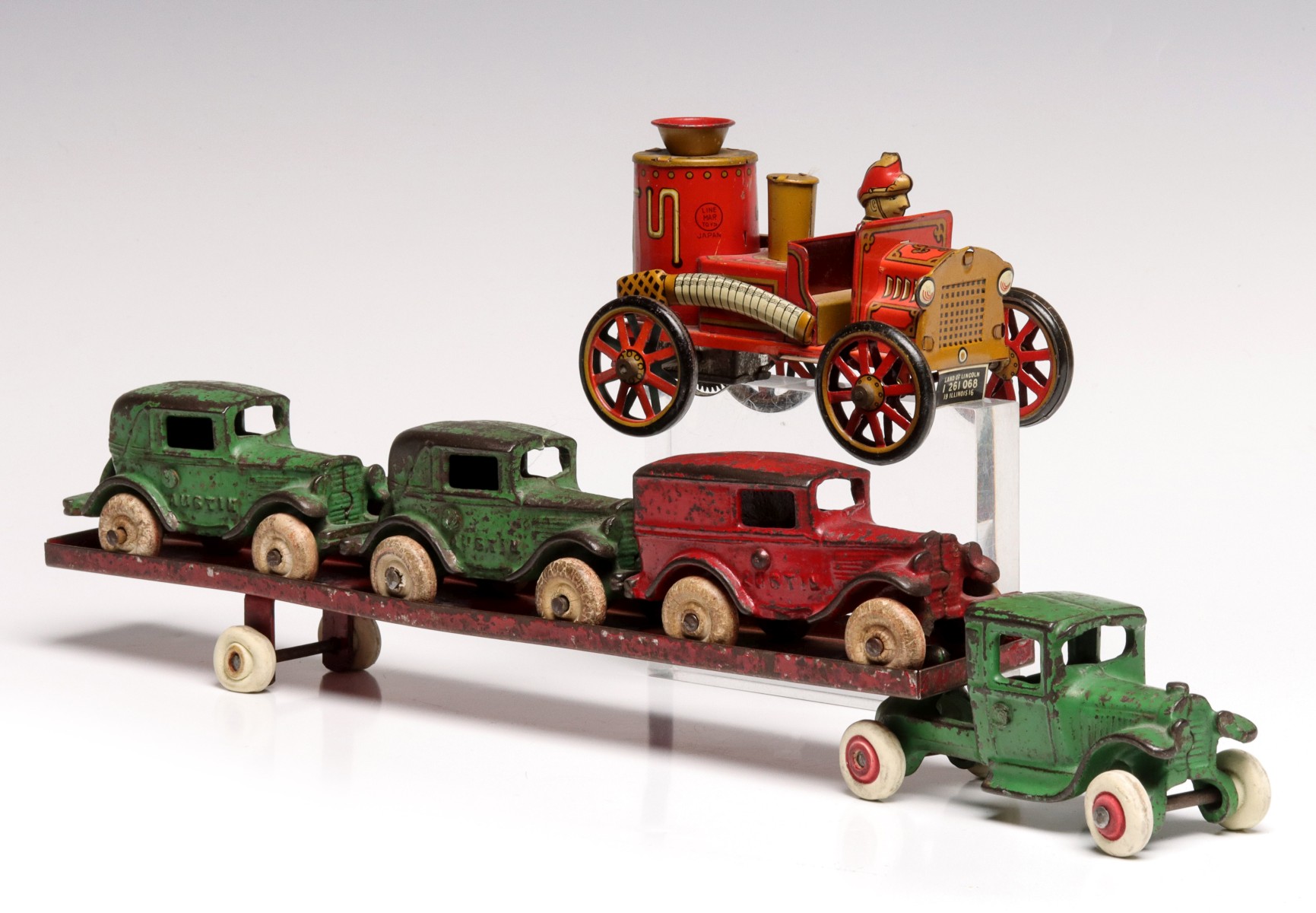 A CAST IRON CAR CARRIER WITH VEHICLES SIGNED ARCADE