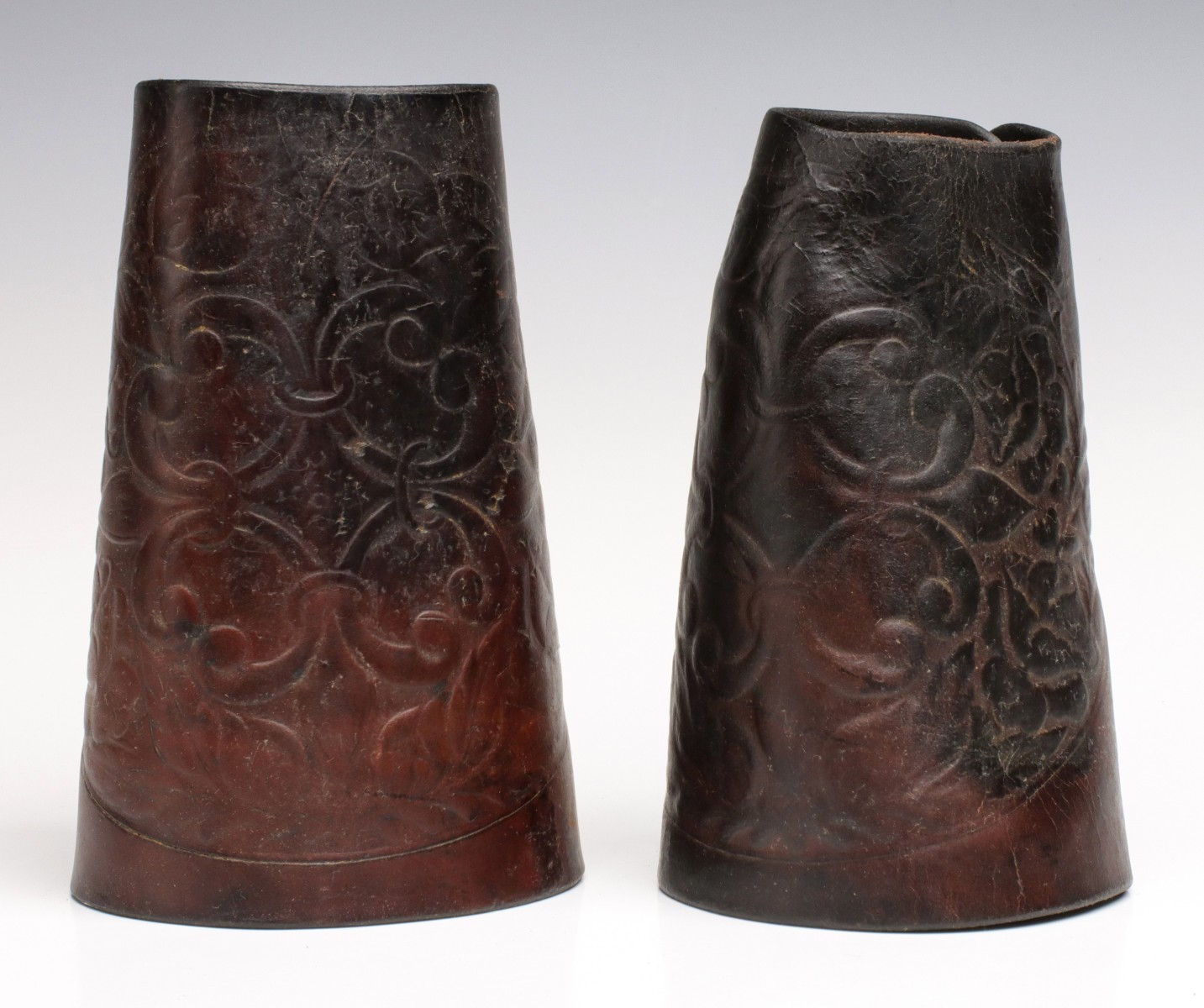 A PAIR OF ASKEW KANSAS CITY HAND TOOLED LEATHER CUFFS