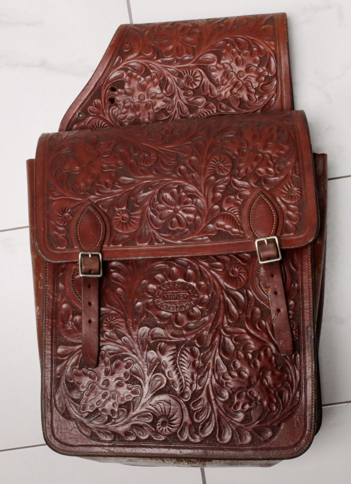 AN ELABORATE PAIR OF DEEPLY CARVED SHIPLEY SADDLE BAGS