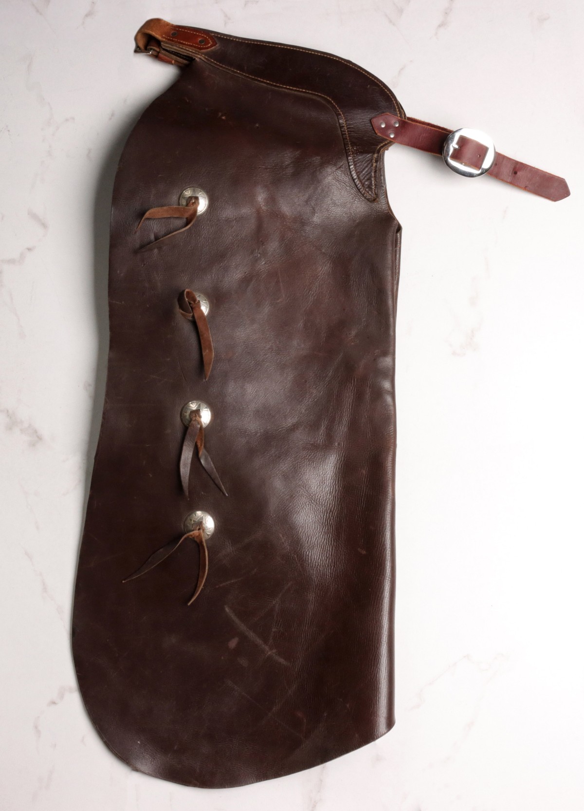 A PAIR OF COWHIDE BATWING CHAPS WITH CONCHOS