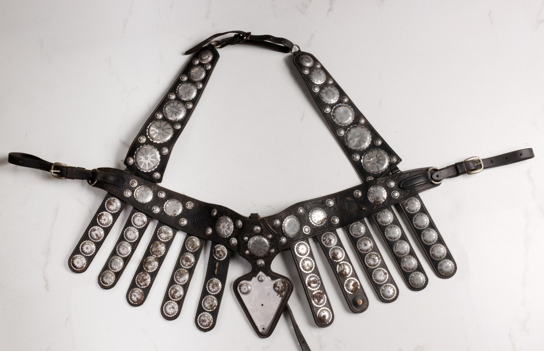 AN ELABORATE BREAST COLLAR WITH METAL MOUNTS