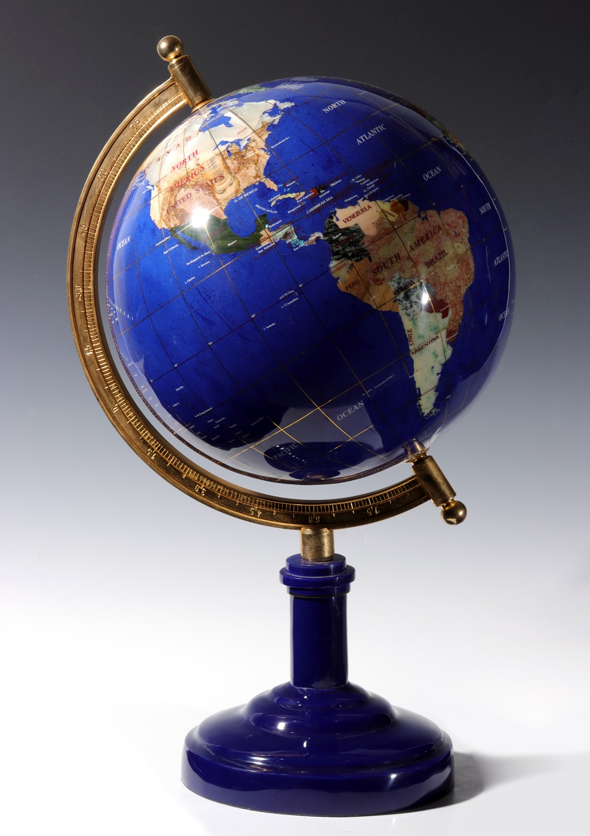 A TERRESTRIAL GLOBE INLAID WITH LAPIS AND OTHER STONE