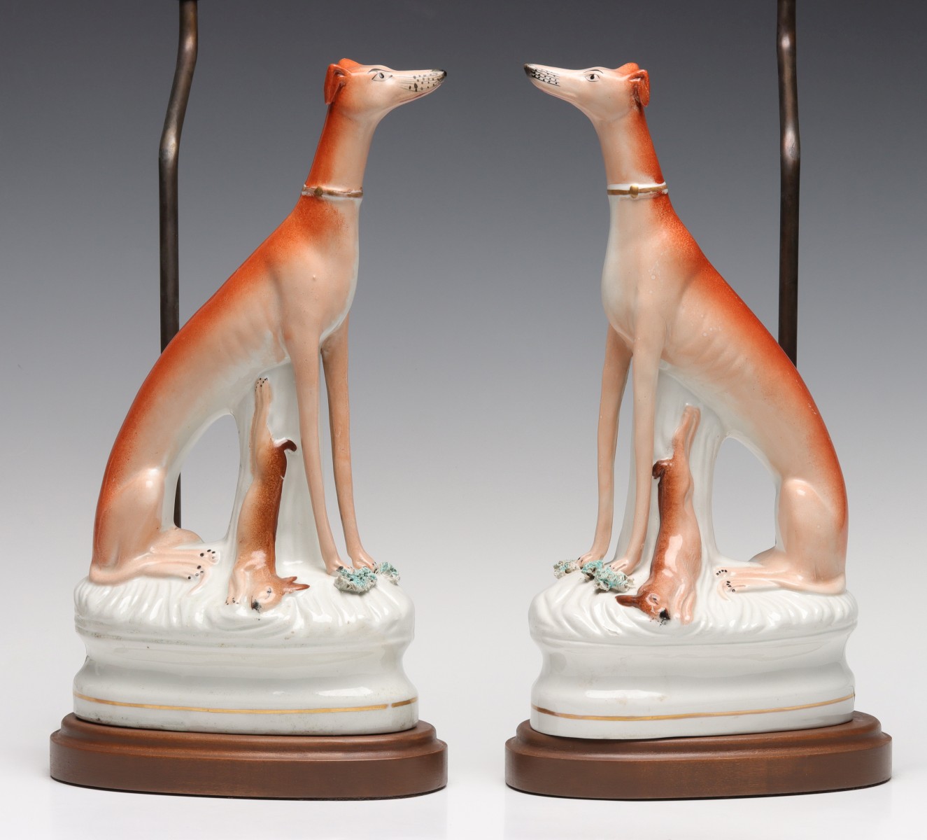 A PAIR 19C. STAFFORDSHIRE POTTERY WHIPPETS NOW LAMPS