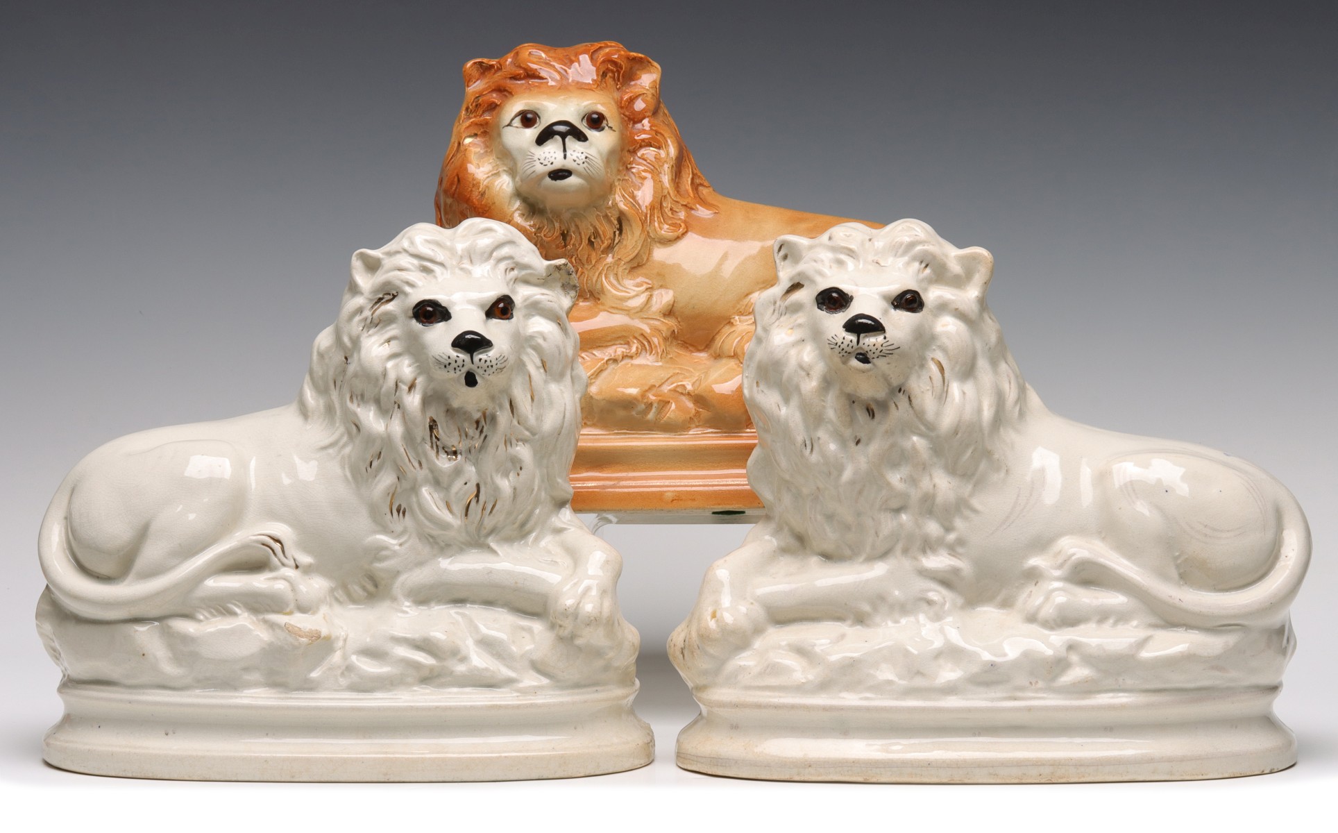 THREE 19TH CENTURY STAFFORDSHIRE POTTERY LIONS