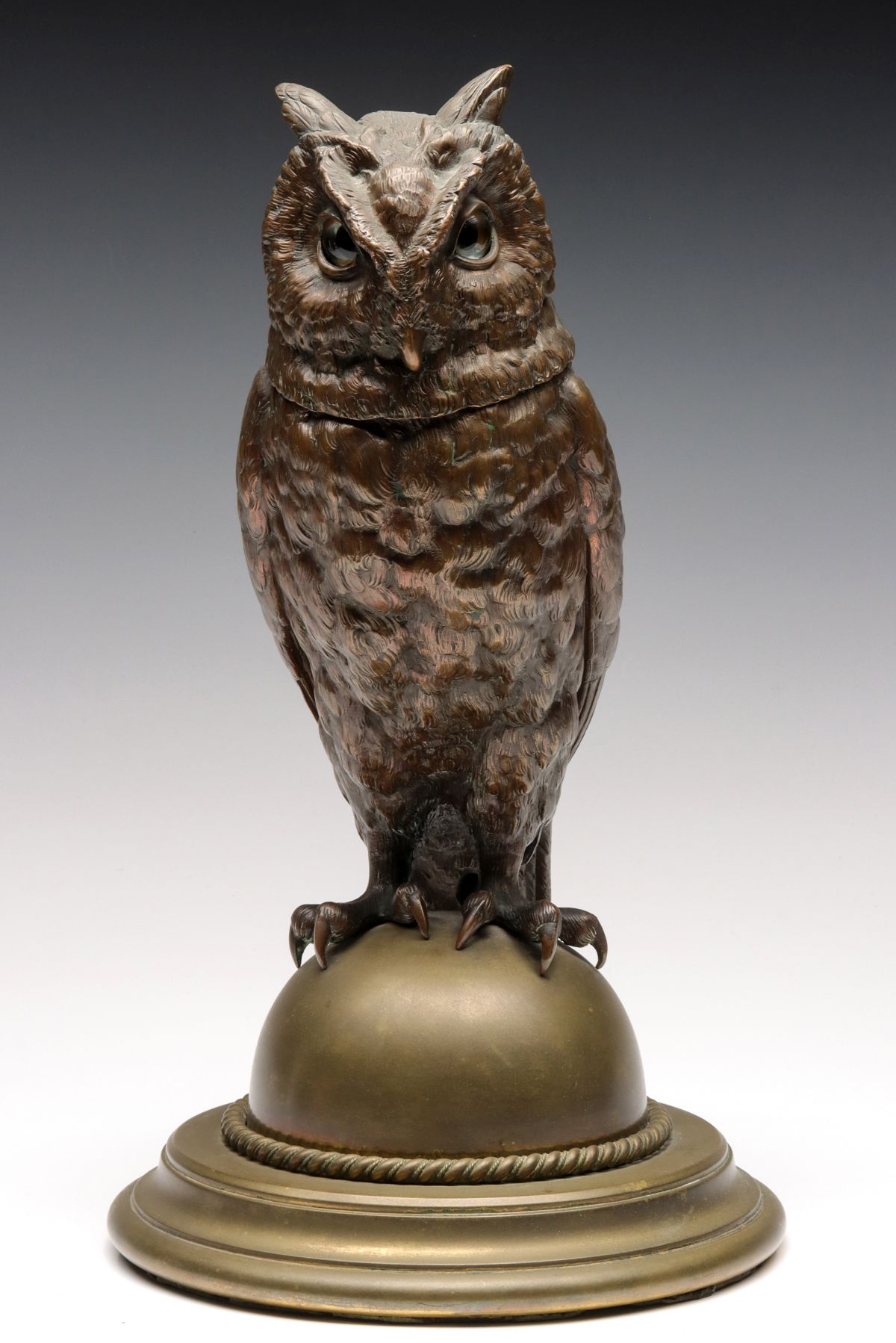 AN EARLY 20C. GLASS EYE AND PATINATED OWL TOBACCO JAR