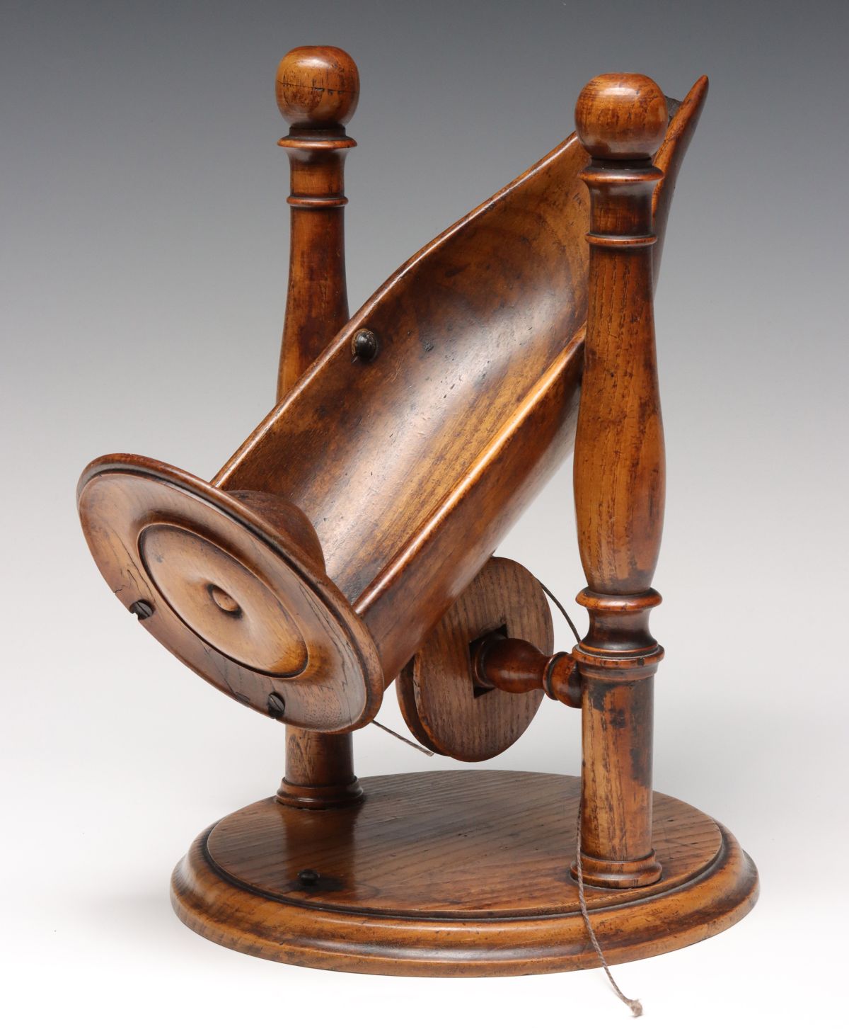 A 19TH CENTURY ENGLISH OAK WINE DECANTING CRADLE