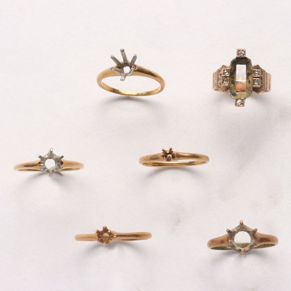 SIX ANTIQUE KARAT GOLD MOUNTINGS WITHOUT STONES