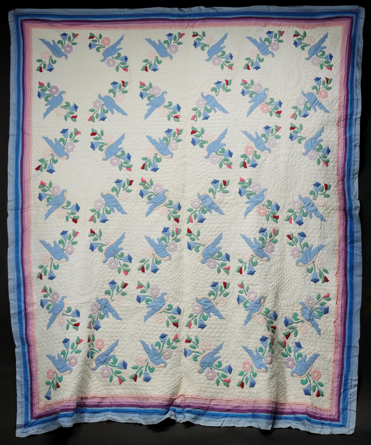 A HIGHLY STUFFED TRAPUNTO BLUEBIRD APPLIQUE QUILT