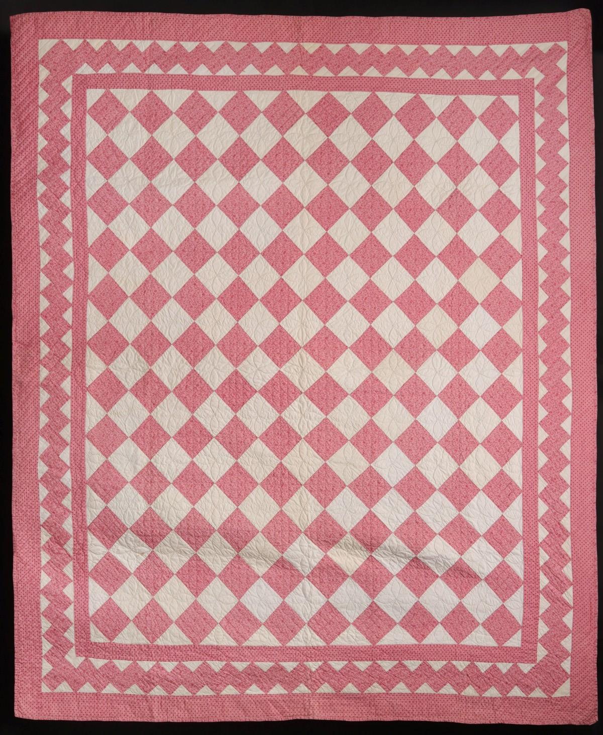 A CIRCA 1900 PINK CALICO FOUR-PATCH PATTERN QUILT