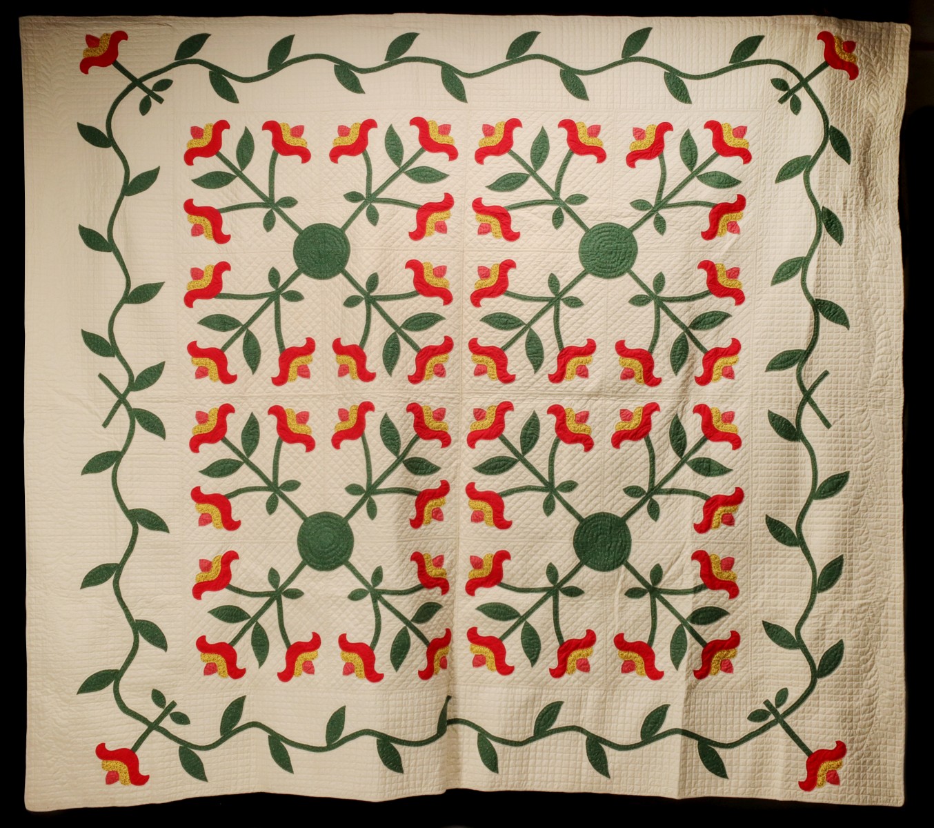 A 20TH CENTURY RED AND GREEN FOUR BLOCK APPLIQUE QUILT