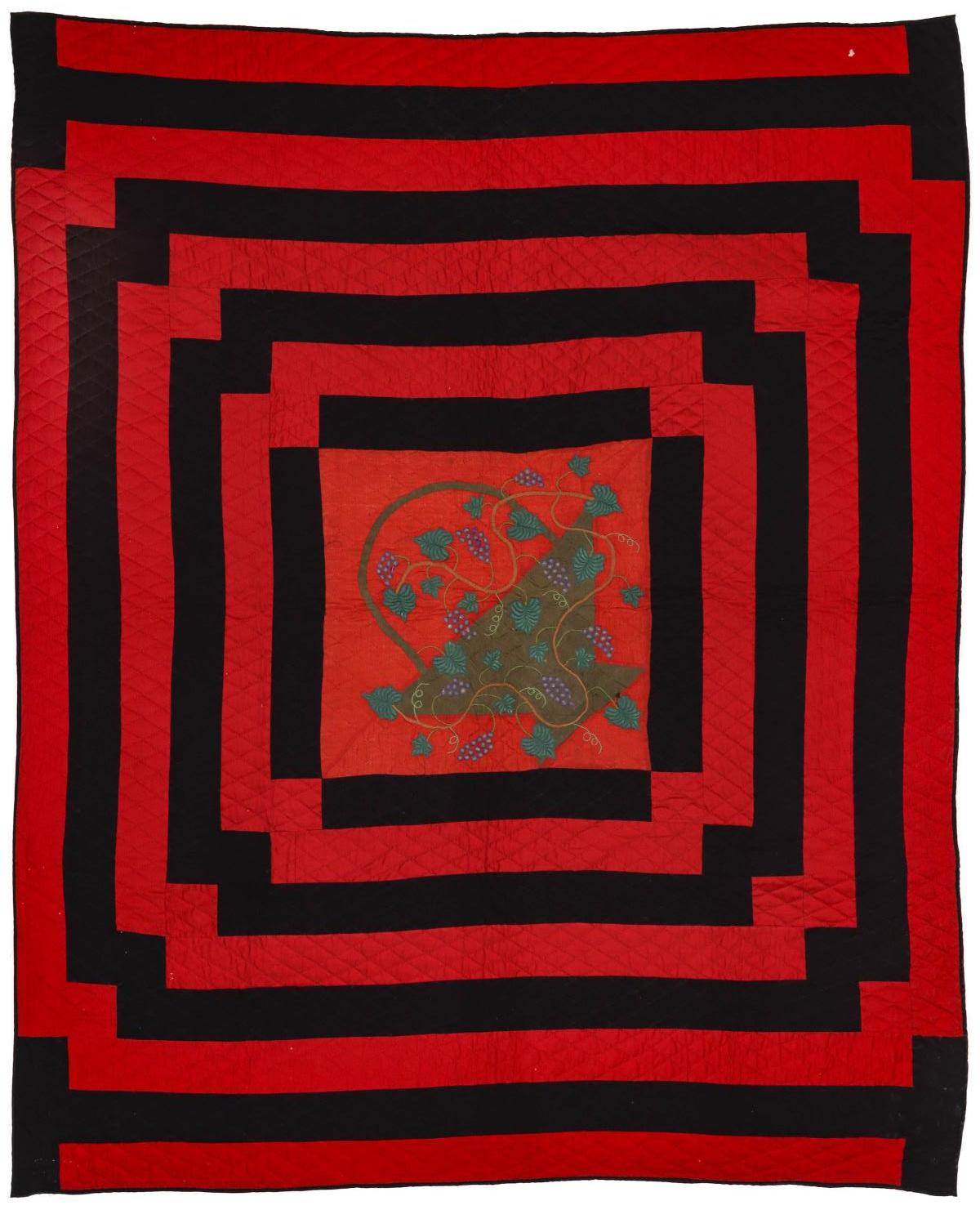 A 19TH C. RED AND BLACK QUILT WITH TRAPUNTO BASKET