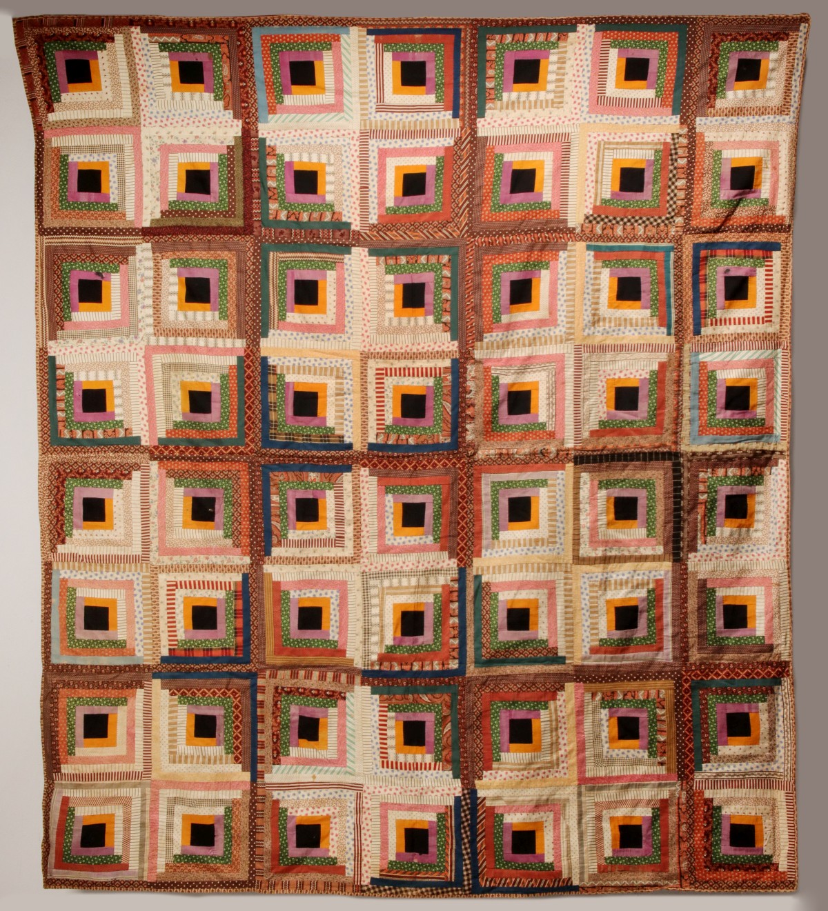 A 19TH CENTURY SATIN LOG CABIN PATTERN QUILT