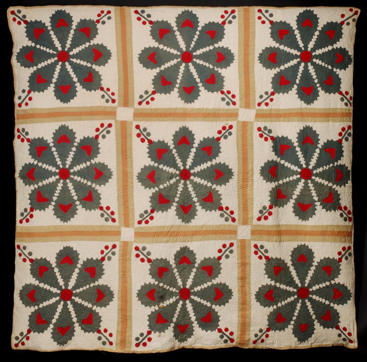 A 19TH CENTURY HOLLY MOTIF APPLIQUE QUILT