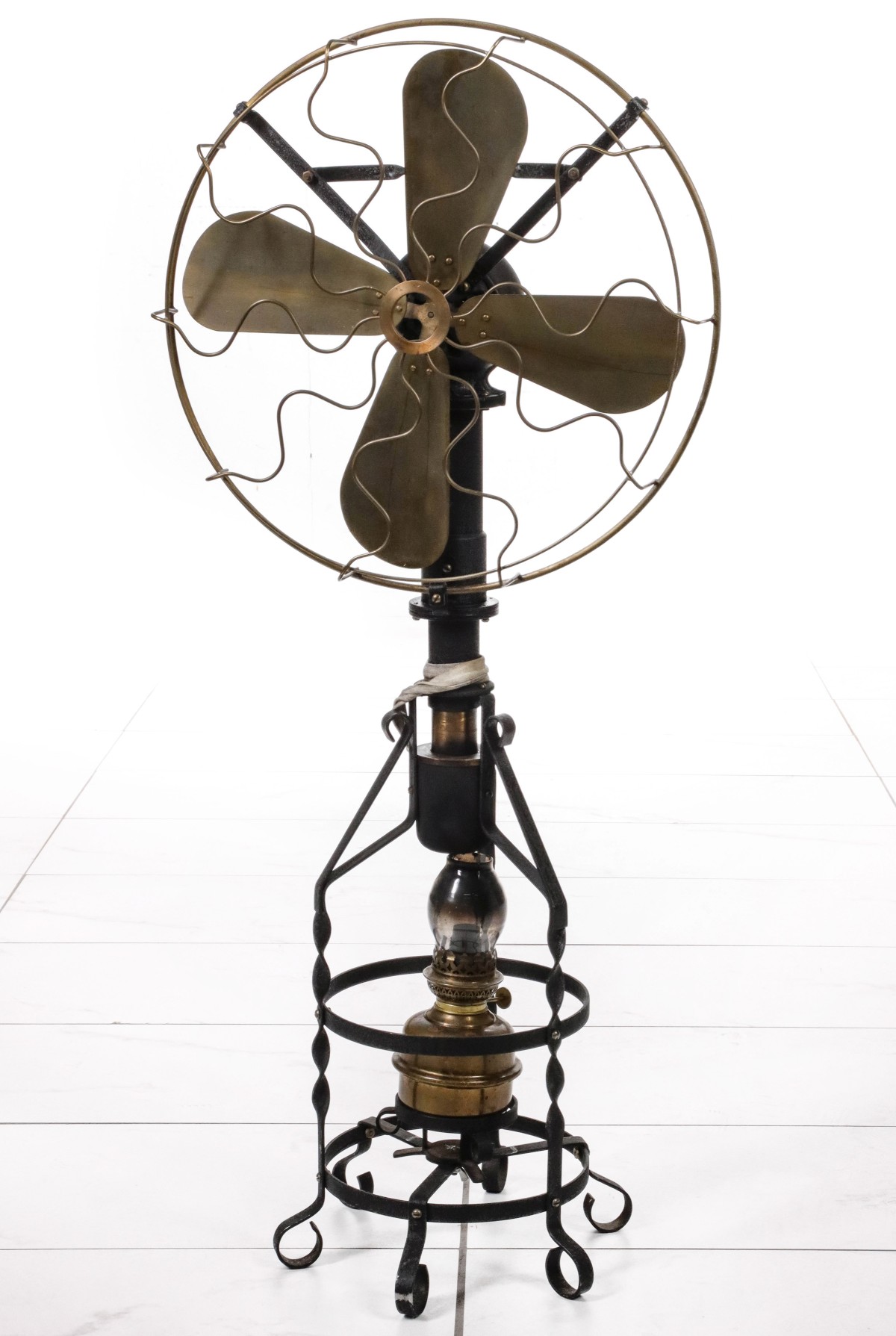 A RARE FLOOR MODEL ALCOHOL POWERED BRASS BLADE FAN