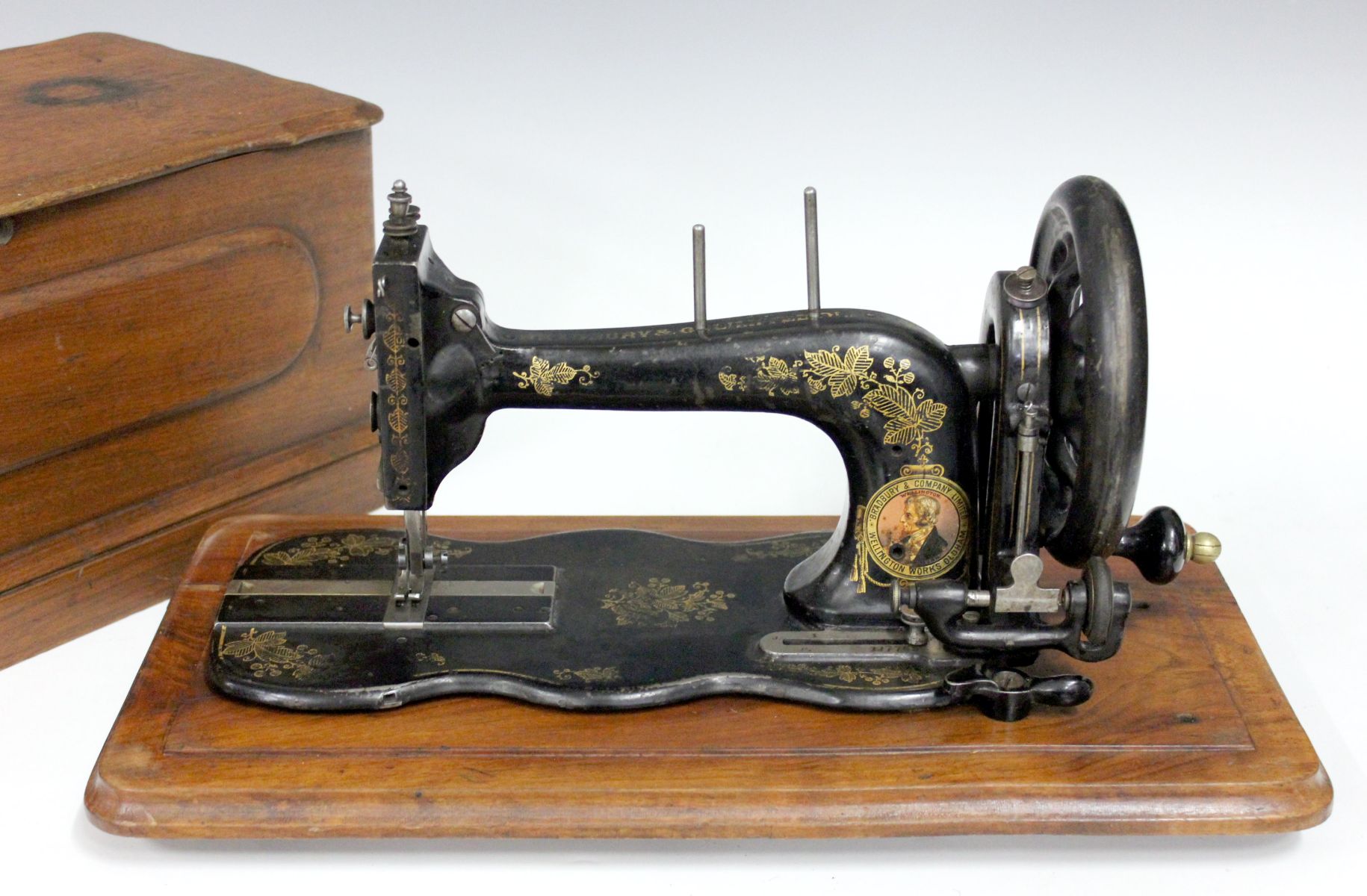 A BRADBURY WELLINGTON CASED FIDDLE BASE SEWING MACHINE