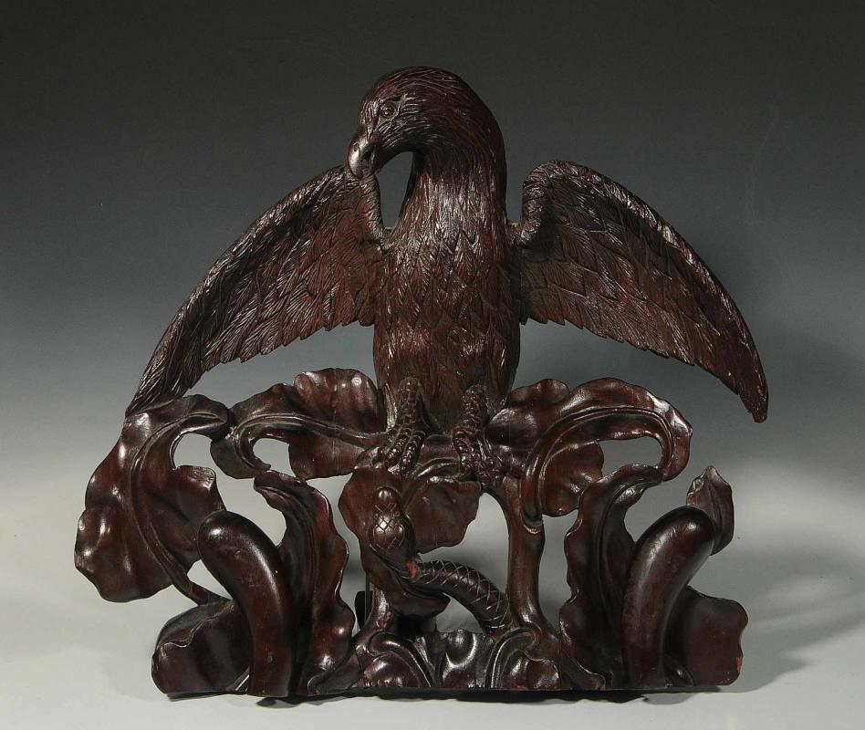 A CARVED MAHOGANY EAGLE AND SNAKE SURMOUNT