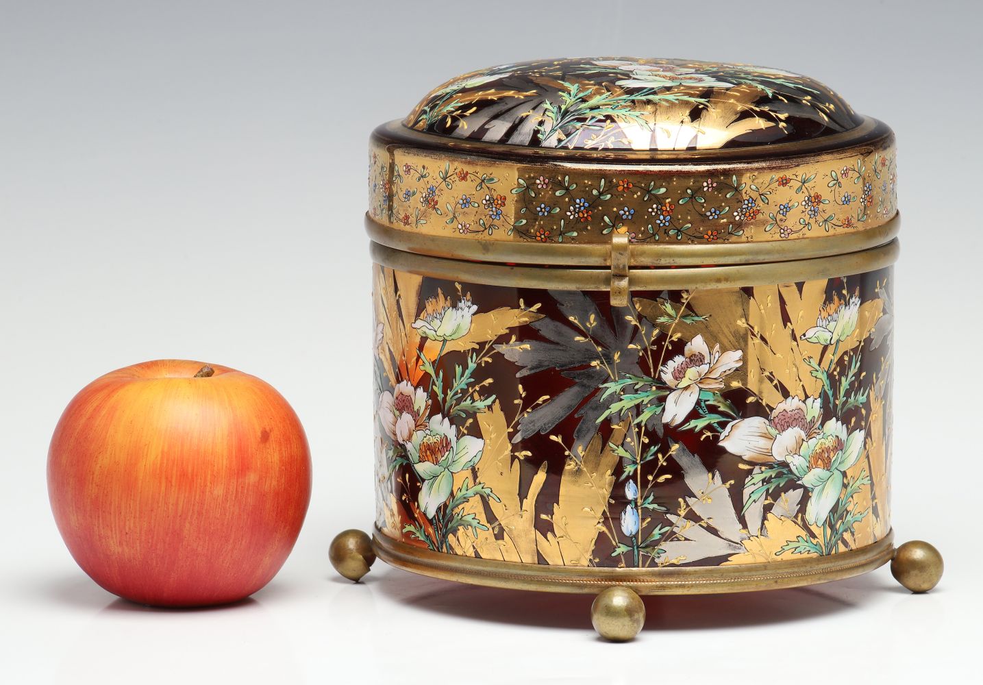 A MOSER DEEP RUBY BOX WITH GILT AND ENAMEL DECORATION