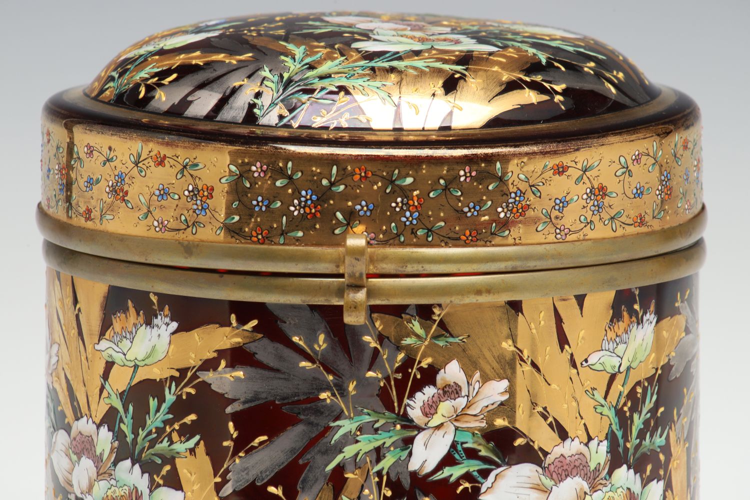 A MOSER DEEP RUBY BOX WITH GILT AND ENAMEL DECORATION