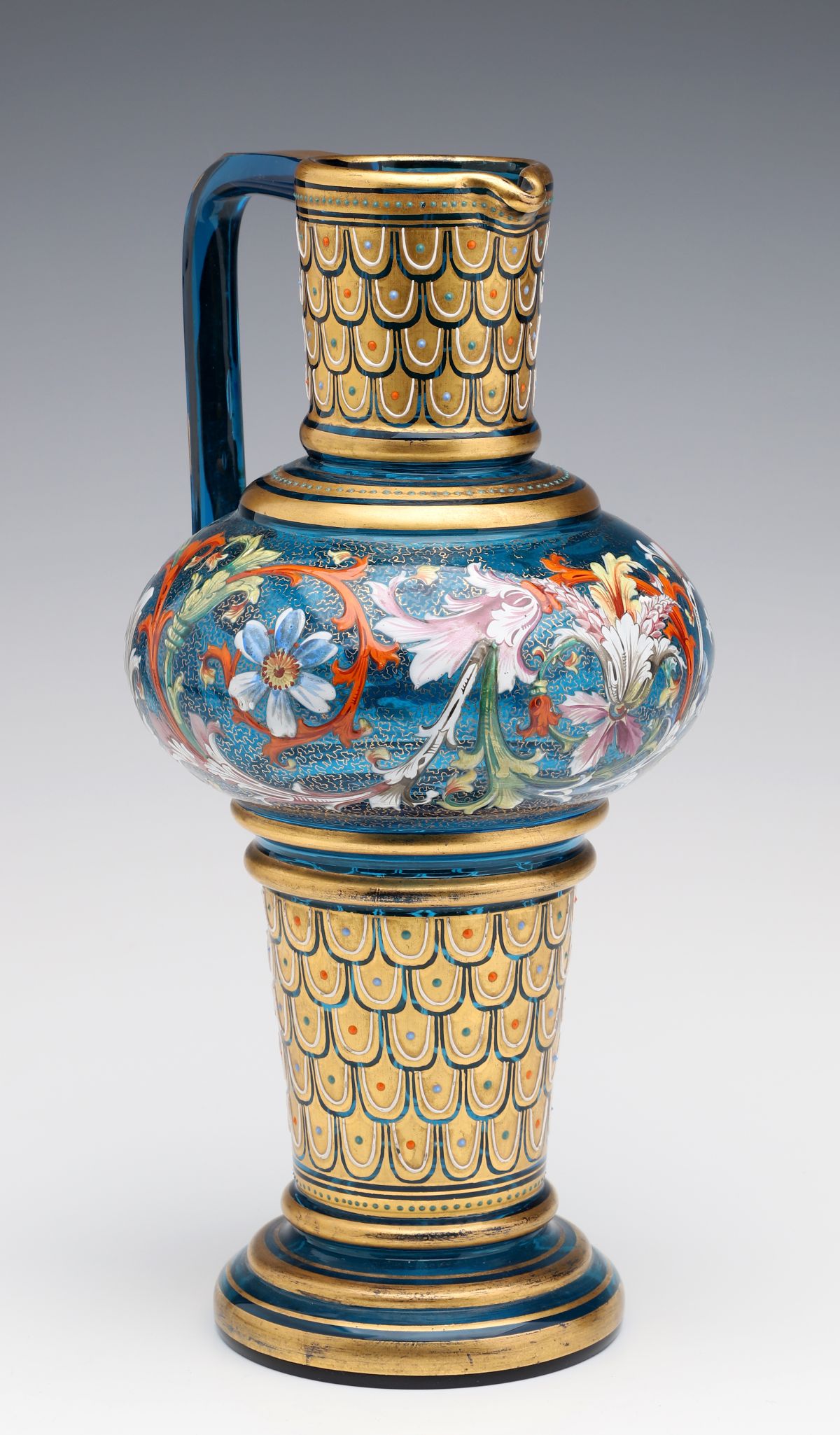 A MOSER BLUE GLASS JUG WITH GILT AND ENAMEL DECORATION