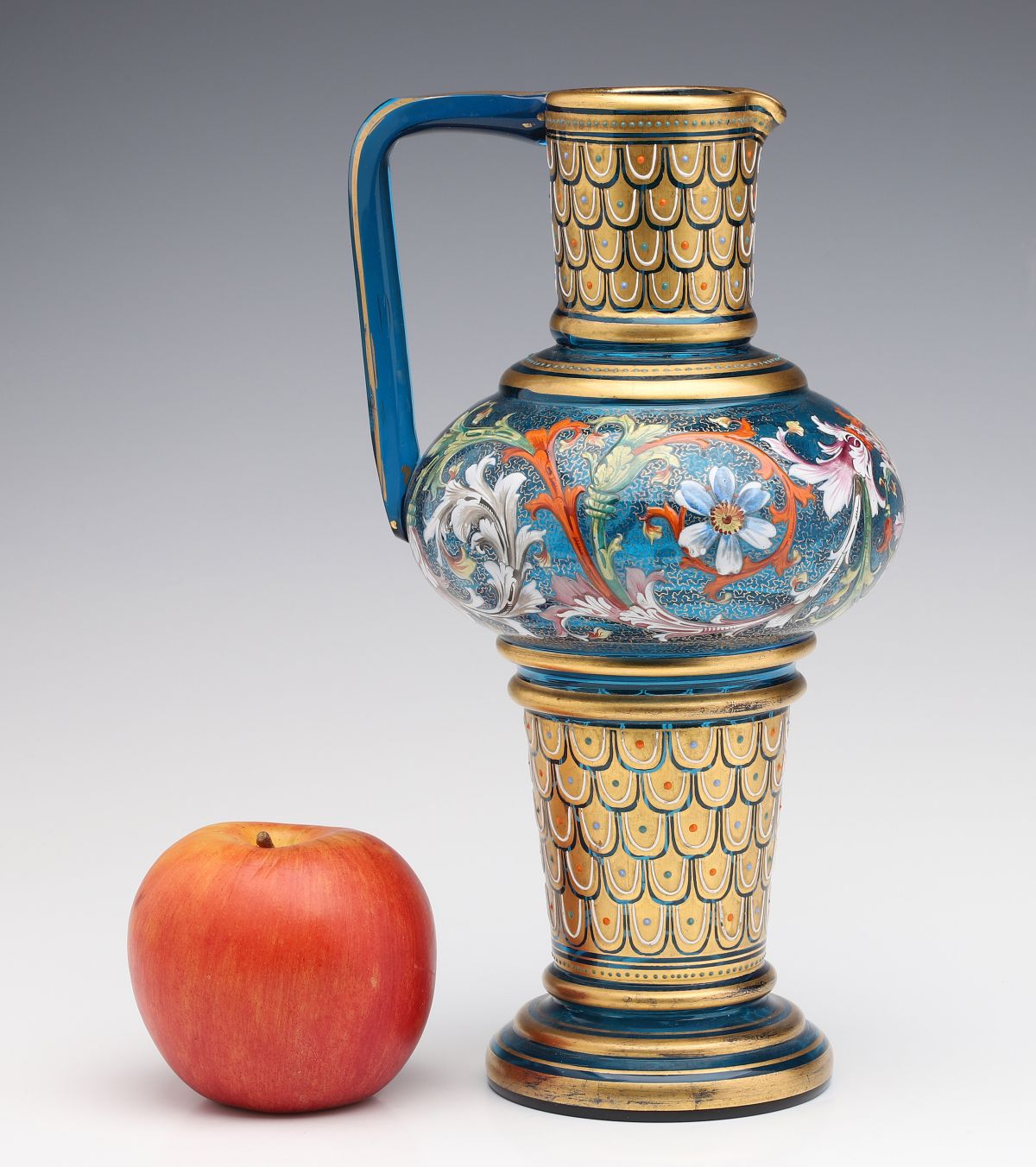 A MOSER BLUE GLASS JUG WITH GILT AND ENAMEL DECORATION